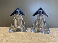 Pair of clear acrylic salt and pepper mills shaped as triangular prisms with triangular chrome tops.