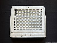 Top view of the vintage cast iron vent grate showing hexagonal mesh pattern and flat border with minor decorative embossing
