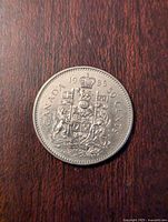 Reverse of the 1985 Canadian 50 cent coin showing the detailed Canadian coat of arms and inscriptions.
