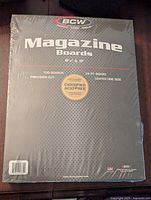 Front view of sealed BCW Magazine Boards package, indicating 100 boards, 24 pt thickness, acid-free, coated on one side.