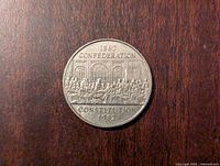 Obverse side of the coin showing 1867 Confederation and Constitution 1982 with a depiction of Fathers of Confederation.