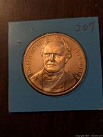 Obverse side of bronze coin showing portrait of Joseph Howe with name and dates