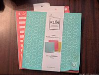 Multiple Kliin reusable towels combo with packaging showing turquoise, red, and yellow towels with geometric and striped patterns.
