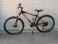 Full left-side profile of the bike showing frame, suspension, wheels and disc brakes