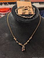 Necklace, bracelet and earrings shown together for lot overview