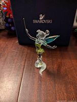 Front view of Tinker Bell crystal figurine with Swarovski box in background