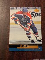 Front of Wayne Gretzky hockey card showing in-action image and player details.