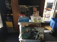 Display of nine vintage vinyl record albums including Kenny Rogers Greatest Hits, 2001 A Space Odyssey, Children's Digest magazine album, Tom Waits, Tina Turner, and others.