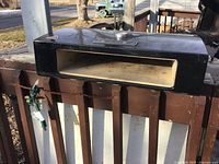 Overhead angled view detailing the black metal body and temperature gauge on the oven insert