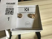 Pair of rose gold toned stud earrings with Swarovski crystals and heart motif in original Katherine Karambelas branding box.