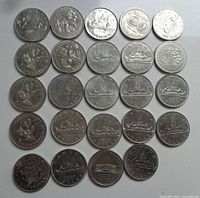 Top-down photo of 24 Canadian nickel dollar coins arranged in rows, showing front and back designs including the Bluenose schooner, commemorative designs, and various mint years.