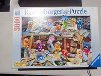 Puzzle box showing Ravensburger 3000-piece Gelini puzzle with cartoon characters and travel theme.