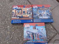 Three unopened 1000-piece Pepsi puzzles showing vintage Pepsi artwork on the boxes.