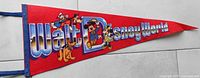 Full view of the red felt Walt Disney World pennant with classic Disney characters and blue edging