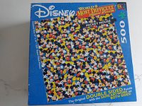 Top view of the puzzle box showing label: World's Most Difficult Jigsaw Puzzle by Disney, 500 pieces, featuring Mickey Mouse faces with the original double-sided artwork printed on both sides.