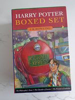 Box set cover of the Harry Potter 3 book box set by J.K. Rowling featuring an illustration of the Hogwarts Express and Harry Potter.