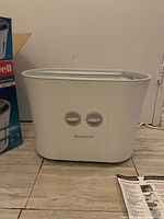 White Honeywell humidifier unit showing front view with control dials and Honeywell logo.