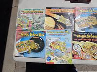 Overview of six Magic School Bus books laid out on a table.