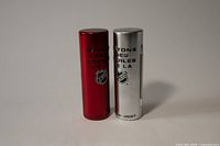 Two cylindrical plastic display cases, one red and one silver, with NHL and McDonald's logos and years 2006-2007 and 2007-2008 printed.