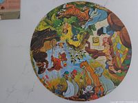 Complete round jigsaw puzzle assembled, showing colorful Disney character illustration with animals around a bed scene.