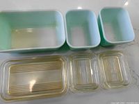 Photo showing three robin egg blue turquoise nested bowls with matching clear ribbed glass lids.