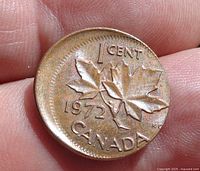 Reverse side of a 1972 Canadian penny showing a double struck error with overlapping maple leaf design and inscriptions.