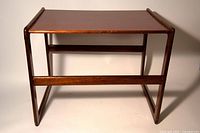 Front view of small wooden side table showing top surface and frame