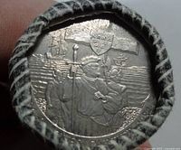 Close-up of the end coin in the roll showing Jacques Cartier and companions with ships background and Canadian shield, detailed embossed coin design.