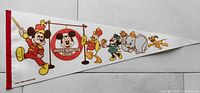 Photo of a vintage white fabric triangular Disney pennant with colorful Mickey Mouse Club characters and number 7 decoration, including Mickey Mouse, Donald Duck, Clarabelle Cow, Dumbo, and Pluto.