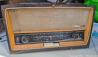 Front view of Grundig 2540 vintage radio showing wood cabinet, speaker grille, tuning dials, and control buttons.