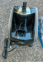 Top view of the main Home Touch vacuum cleaner body in black and silver with power cord attached, showing control dial and inlet connection