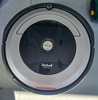 Top view showing the main 'CLEAN' button and circular design with black and silver coloring.