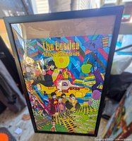 Front view of The Beatles Yellow Submarine framed puzzle showing full colorful puzzle artwork inside black frame and glass.