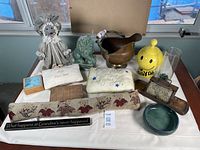 Wide view of the assortment, showing all included items on a white cloth in front of a window