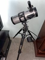 Side view of Magnicon Universe 1000 telescope mounted on adjustable tripod with counterweight and focuser with eyepiece.