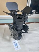 Side view of closed expandable movie set style light with barn doors open showing overall condition and structure.