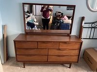 Front view of seven-drawer dresser with attached mirror