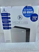 Front of retail box showing model name, features like HEPA H13 filter, wall mount, room coverage up to 772 sq ft, carbon filter, and air quality sensor.
