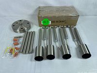 Photo of all ceiling light fixture components including four cylindrical light holders attached to metal rods, round mounting plate, additional metal rods, and installation connectors.