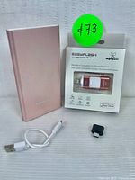 Easyflash flash drive in original packaging with USB cable and small adapter beside it, all placed on white surface