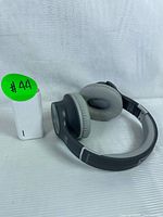 View of headphones and power bank showing overall condition and color