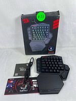 Redragon DITI keyboard displayed with original box, USB cable, user manual, and promotional card on white background.