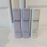 Three Attitude Oceanly skincare sticks shown upright: face serum, face cream, and oil-to-milk cleanser, side by side, in original packaging.