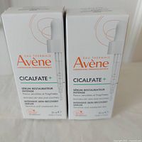 Two unopened boxes of Avene Cicalfate+ serum standing side by side with front packaging visible.