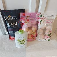 Photo of all four items showing Yardley talc, Westlab bath salt, and two Bodycology bath fizzies in bags.