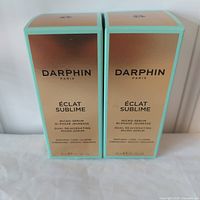 Two unopened boxes of Darphin Éclat Sublime Dual Rejuvenating Micro-Serum 30ml each, front view.