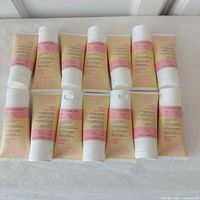 14 tubes laid out on flat surface showing front labels and product branding.