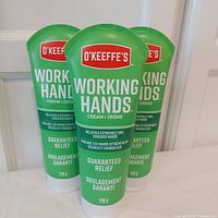 Front view of 3 green tubes of O'Keeffe's Working Hands Cream, showing brand and product details.