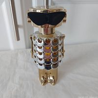 Front view of Paco Rabanne Fame 80ml perfume tester bottle shaped like a gold and silver robot with black sunglasses.