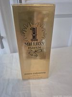 Front view of sealed Paco Rabanne 1 Million Parfum 100ml box in gold packaging.